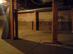 Looking across the basement below the auditorium.  In the wall you can see notches for the cross beams that supported the auditorium's sloped floor, before it was replaced with a level floor for an office supply store. - , Utah